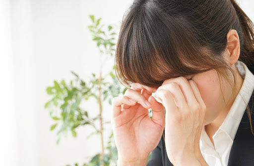 A woman rubbing her dry eyes